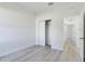 Bedroom with closet, gray wood-look flooring, and crisp white walls and trim at 4415 Sw 169Th Lane Rd, Ocala, FL 34473