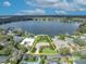 Breathtaking aerial view of a lakefront property with lush landscaping and direct access to the water at 443 Lakewood Dr, Winter Park, FL 32789