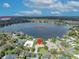 Stunning aerial view of lakefront property with lush landscaping and a serene lake Osceola backdrop at 443 Lakewood Dr, Winter Park, FL 32789