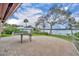 Spacious tiled back patio with white metal railing overlooking a serene lake view and mature trees at 443 Lakewood Dr, Winter Park, FL 32789