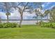 Beautiful lake view from the backyard, with mature landscaping framing the waterfront at 443 Lakewood Dr, Winter Park, FL 32789