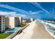 Scenic aerial view of the condo complex with direct beach access and a sparkling pool at 4495 S Atlantic Ave # 5020, Ponce Inlet, FL 32127