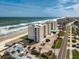 Beautiful aerial view of oceanfront condo building with private beach access and scenic coastal views at 4495 S Atlantic Ave # 5020, Ponce Inlet, FL 32127