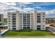 Exterior shot of a multi-story building with balconies, green lawn, and ocean view at 4495 S Atlantic Ave # 5020, Ponce Inlet, FL 32127