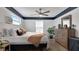 Cozy bedroom with a ceiling fan, dark trim, and lots of natural light at 48 Carriage Hill Cir, Casselberry, FL 32707