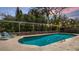 Inviting backyard pool area with lounge chairs for relaxation, surrounded by lush greenery for privacy at 48 Carriage Hill Cir, Casselberry, FL 32707