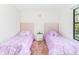 Charming bedroom featuring two twin beds with pink headboards, moon pillows and pink carpet at 502 Summer Place Loop, Clermont, FL 34714