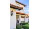 Charming exterior featuring a terracotta roof, inviting porch and manicured shrubs at 502 Summer Place Loop, Clermont, FL 34714