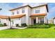 Charming two-story home with a terra cotta roof, well-manicured lawn, and a spacious two car garage at 502 Summer Place Loop, Clermont, FL 34714