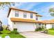 Charming two-story home with a terra cotta roof, well-manicured lawn, and a spacious two car garage at 502 Summer Place Loop, Clermont, FL 34714