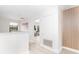 Bright hallway with modern white walls, wood accents, and view to the study room at 502 Summer Place Loop, Clermont, FL 34714