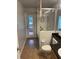 A well-lit bathroom featuring a shower with glass door, granite counters and tile flooring at 527 Buckhaven Loop, Ocoee, FL 34761