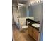 A bathroom with a shower/tub, neutral gray walls, tile flooring, and wood cabinets at 527 Buckhaven Loop, Ocoee, FL 34761