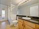 Well-lit bathroom featuring granite countertops, wooden cabinets, and a shower-tub combination at 527 Buckhaven Loop, Ocoee, FL 34761