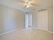 Bedroom featuring tile flooring, closet, ceiling fan, and neutral paint at 527 Buckhaven Loop, Ocoee, FL 34761