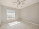 Bright bedroom with neutral walls, tile flooring, a ceiling fan, and a large window with horizontal blinds at 527 Buckhaven Loop, Ocoee, FL 34761