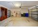 Functional garage space with shelving, and an automatic door for convenient vehicle storage at 527 Buckhaven Loop, Ocoee, FL 34761