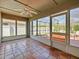 Enclosed sunroom with tile floors, ceiling fan, and bright views of the fenced-in backyard at 527 Buckhaven Loop, Ocoee, FL 34761