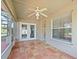 Enclosed sunroom with tile flooring, a ceiling fan, and access to the patio and the main house at 527 Buckhaven Loop, Ocoee, FL 34761