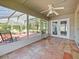 The sunroom with tile floors features a ceiling fan, and access to the screened-in patio and backyard at 527 Buckhaven Loop, Ocoee, FL 34761