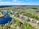 High aerial view showing a pond with houses near a road and lush green landscapes for a picturesque scene at 558 Osprey Lakes Cir, Chuluota, FL 32766