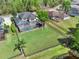 Aerial view of a home with a pool, a large backyard surrounded by a fence and lush green landscape at 558 Osprey Lakes Cir, Chuluota, FL 32766