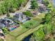 Aerial view of the property with a pool and large backyard near a beautiful pond, in a serene neighborhood at 558 Osprey Lakes Cir, Chuluota, FL 32766