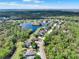 Lush green trees surround the houses of this community with a pond nearby for a serene living at 558 Osprey Lakes Cir, Chuluota, FL 32766