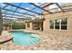 A beautiful backyard featuring a swimming pool and a screened-in patio at 558 Osprey Lakes Cir, Chuluota, FL 32766