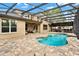 A luxurious backyard featuring a swimming pool, patio and a screened-in lanai with comfortable seating at 558 Osprey Lakes Cir, Chuluota, FL 32766