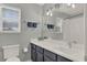 Well lit bathroom features a large window with blinds and a vanity with a white countertop at 558 Osprey Lakes Cir, Chuluota, FL 32766