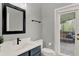 Bathroom featuring a vanity with a white countertop, a mirror and a sliding door to the patio at 558 Osprey Lakes Cir, Chuluota, FL 32766