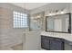 Beautiful bathroom featuring tiled walls and glass block window to allow natural light into the walk in shower at 558 Osprey Lakes Cir, Chuluota, FL 32766