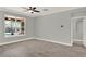 Bright bedroom with a view of the covered patio and pool and a doorway leading to another room at 558 Osprey Lakes Cir, Chuluota, FL 32766