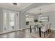 Dining area featuring decorative front doors, modern lighting, and space for a table and chairs at 558 Osprey Lakes Cir, Chuluota, FL 32766