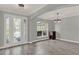 Dining area featuring decorative front doors and modern lighting in the spacious dining room at 558 Osprey Lakes Cir, Chuluota, FL 32766