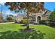 Beautiful home with a well-maintained lawn, mature tree, and an arched doorway at 558 Osprey Lakes Cir, Chuluota, FL 32766