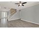 Open living room with wood-look floors, modern staircase, and neutral paint, providing a blank canvas at 558 Osprey Lakes Cir, Chuluota, FL 32766