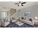 Beautiful living room with neutral-colored furniture, a striking blue patterned rug, and a ceiling fan at 558 Osprey Lakes Cir, Chuluota, FL 32766