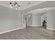 Bright and airy living room featuring hardwood floors, neutral colors, and modern lighting at 558 Osprey Lakes Cir, Chuluota, FL 32766