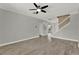 Spacious living room featuring hard surface flooring, ceiling fan and staircase to second floor at 558 Osprey Lakes Cir, Chuluota, FL 32766