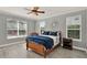 Main bedroom with hard surface flooring, ceiling fan and two windows at 558 Osprey Lakes Cir, Chuluota, FL 32766