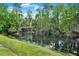 Scenic pond view with lush landscaping and charming wooden bridge adding to the tranquil setting at 558 Osprey Lakes Cir, Chuluota, FL 32766