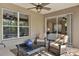 Cozy screened porch featuring comfortable seating and tranquil views of the backyard at 558 Osprey Lakes Cir, Chuluota, FL 32766