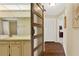 Hallway featuring a bathroom with a sliding barn door and a vanity with decorative wallpaper at 600 Heather Brite Cir, Apopka, FL 32712