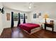 Bright bedroom featuring hardwood floors, a ceiling fan, and ample natural light at 600 Heather Brite Cir, Apopka, FL 32712