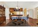 Dining room showcasing wooden floors, an ornate rug, and an adjoining kitchen with wood cabinetry at 600 Heather Brite Cir, Apopka, FL 32712