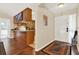 Inviting entrance and view of the kitchen with light walls, wood floors, and modern appliances at 600 Heather Brite Cir, Apopka, FL 32712