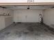 An empty garage with water heater, tools, and an American flag at 8040 Equitation Ct, Orlando, FL 32818