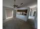 Large living room with large sliding glass door and breakfast bar to the kitchen at 8040 Equitation Ct, Orlando, FL 32818